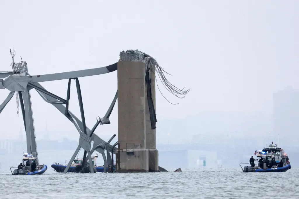Emergency boats work near the collapsed section of the Francis Scott Key Bridge, after the Dali cargo vessel crashed into it, in Baltimore, Maryland, U.S., March 27, 2024. REUTERS/Mike Segar     TPX IMAGES OF THE DAY