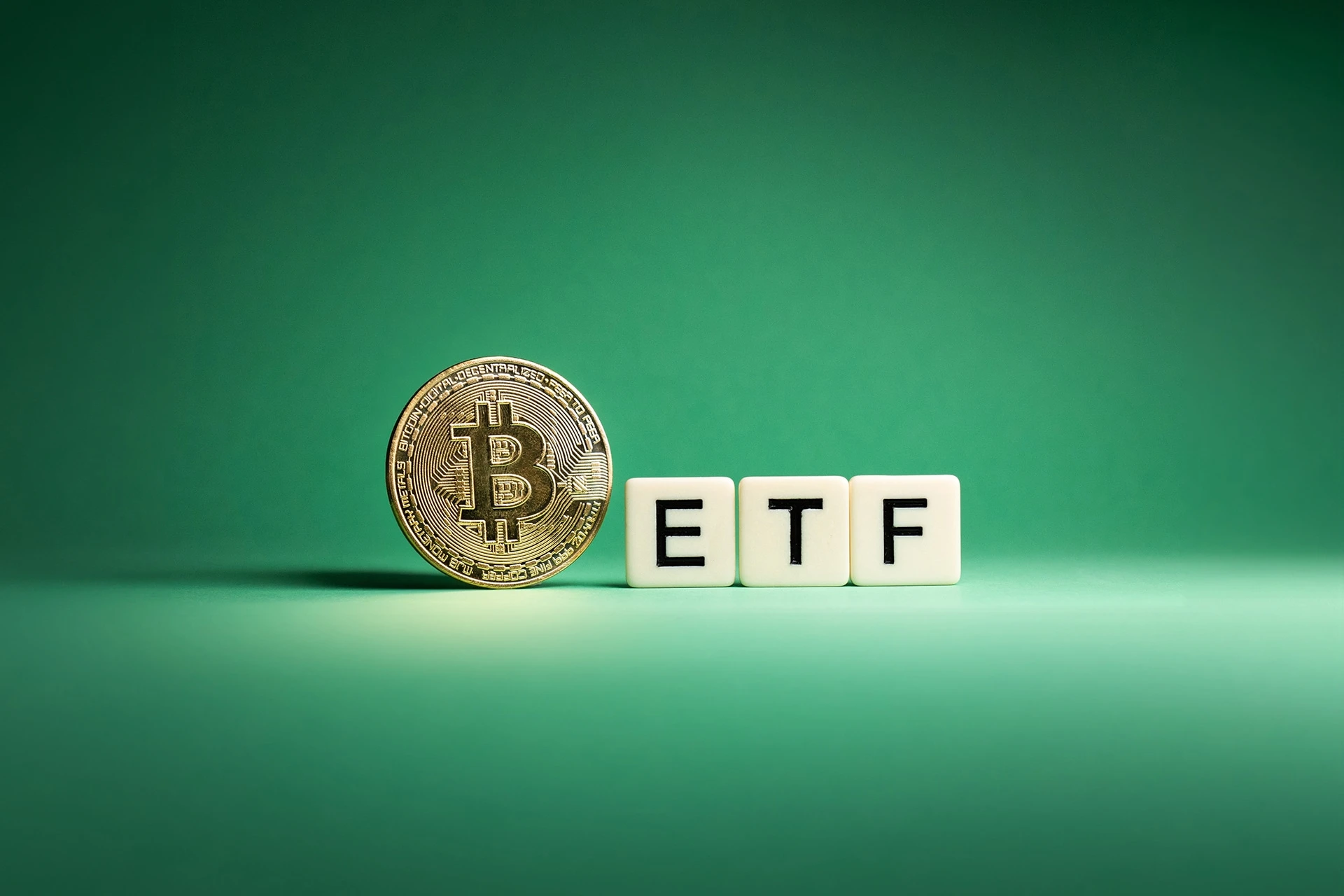 Vancouver, BC, Canada - July 5, 2023: Bitcoin ETF Concept, Cryptocurrency ETF on a green background