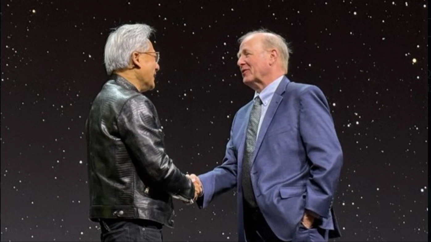 IonQ chair Peter Chapman (right) and Nvidia CEO Jensen Huang (left) shake hands. In January, Huang’s comment about the future of quantum technologies caused IonQ to lose almost 40% of market value in a single day. / Photo: X/IonQ