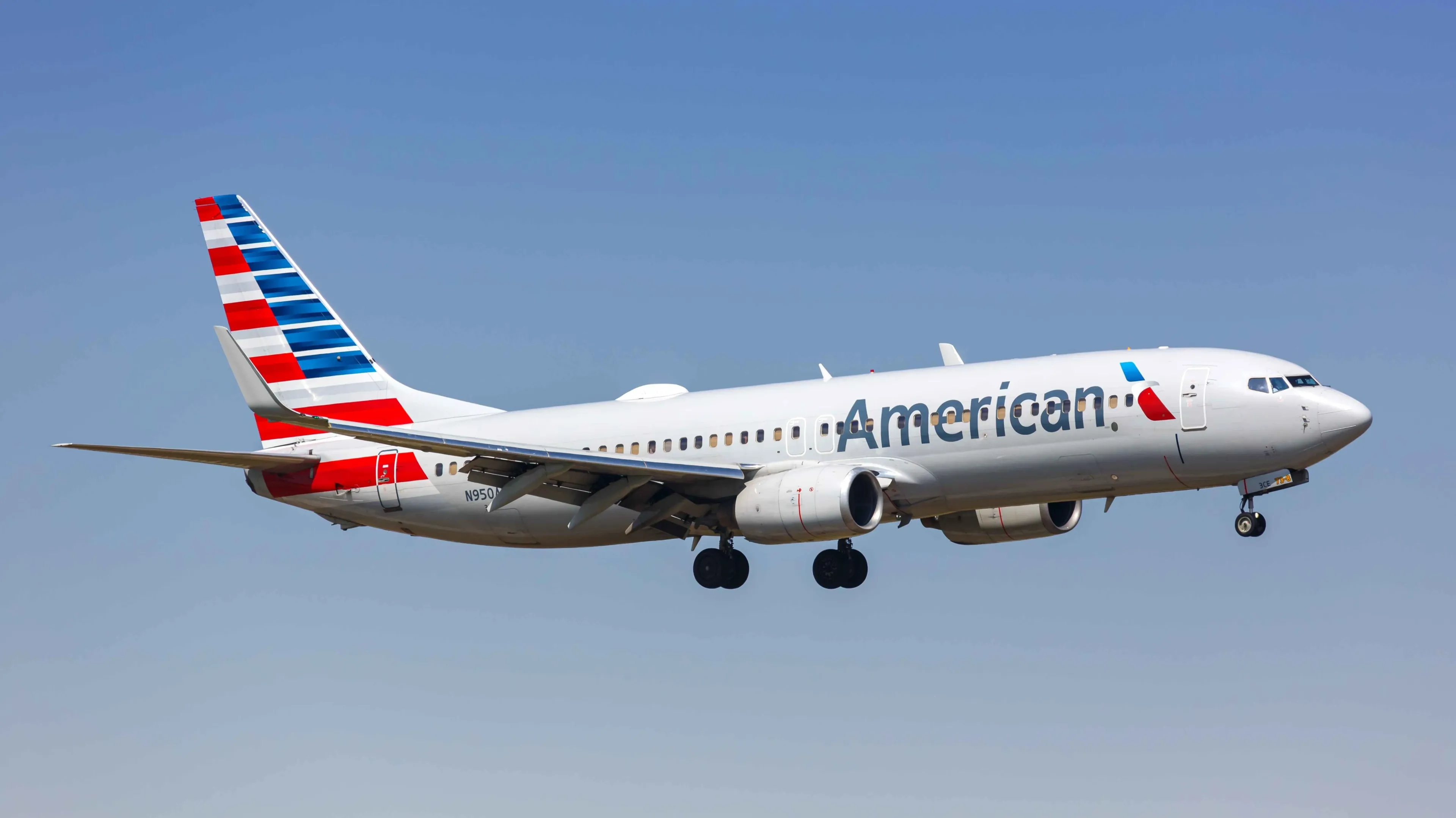 American improved its outlook thanks to champagne and coffee on board. Shares soared 6%